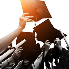 Graduation caps and diplomas, hands celebrating