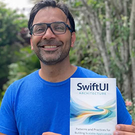 AIU Professor Mohammad Azam holding a copy of his new book