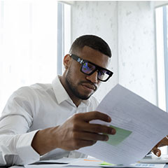 Manger reading corporate document in an office