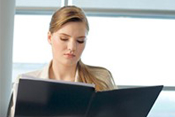 Woman reading business portfolio in an office