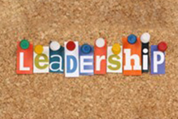 The word “leadership” spelled out with colorful letters pinned to a corkboard.