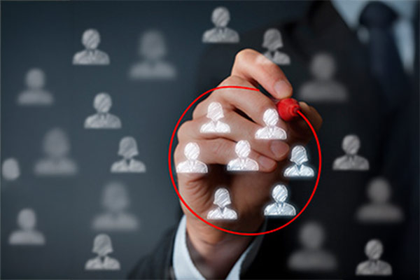 Hand selecting employee candidate icons on a digital interface